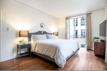 a bedroom with a large bed and a large window at Villa Carlotta – Furnished Apartments, Los Angeles, 90028